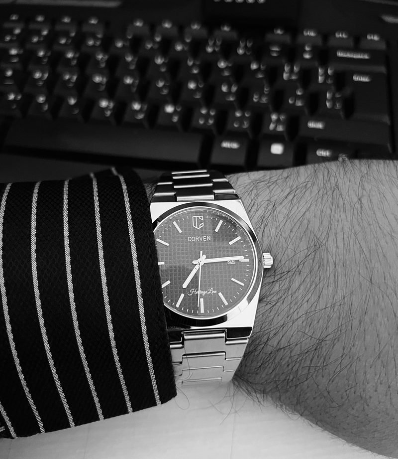 Corven Nocturne on the wrist with a pinstripe shirt, photographed in black and white