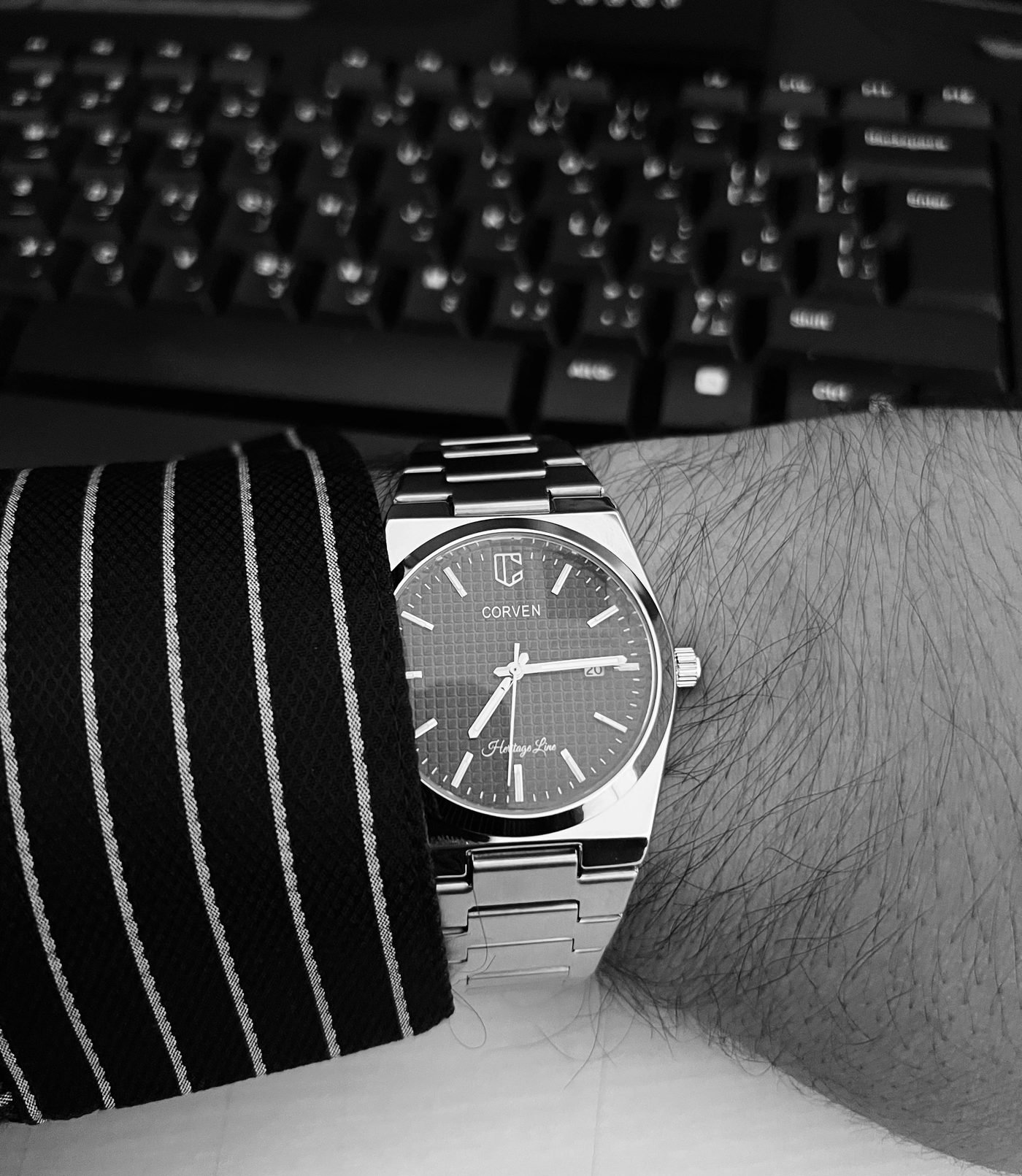 Corven Nocturne on the wrist with a pinstripe shirt, photographed in black and white